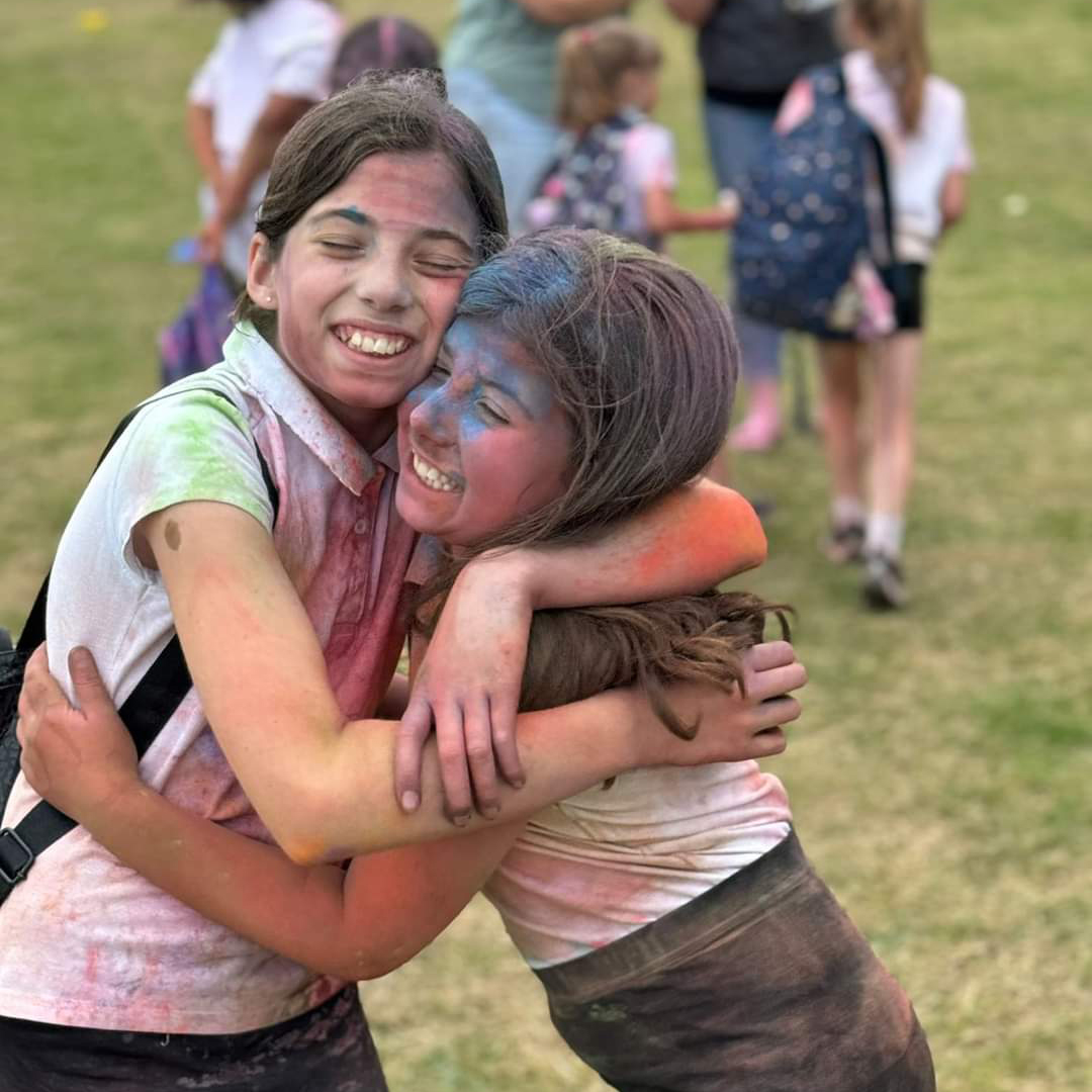 Colour Run students hugging